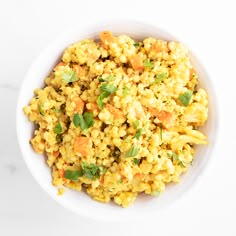 a white bowl filled with rice and vegetables