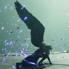 two people in front of a large bird with blue lights on it's wings