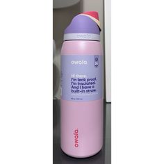 a pink and purple bottle sitting on top of a counter