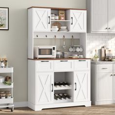 a kitchen with white cabinets and wooden floors