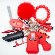 the contents of a red purse are laid out on a white surface, including scissors and other accessories