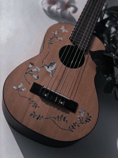 a ukulele with flowers and butterflies on it