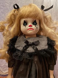 a creepy doll with blonde hair and blue eyes