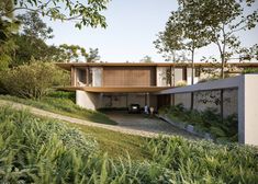 an artist's rendering of a modern house in the woods with trees and bushes