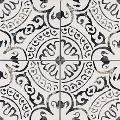 black and white tile with an intricate design on the bottom, in four different colors