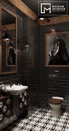 a black and white tiled bathroom with two pictures on the wall above the toilet area