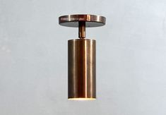 1 light Ceiling Spot Light | Directional Lighting | Spotlight | Modern Light Fixture size : 2.5''W X 2.5''D X 8.5''H Canopy ( Back Plate ) : 4'' inch Material : Brass The second swivel has knob to let you adjust the angle by hand , could be turned about (0 - 90 degree is enough) in vertical direction. Specifications, Socket : E - 26 Medium stand base, UL Listed. dimmable Watt : 60 max Volt : 110 - 220V Bulb : Medium base bulb, We provide a 4w (45w eq) LED for free. Wiring : Hardwired from ceiling. Light is un - lacquered finish. we hand clean each brass part . Brass parts will darken and patina over time. Note: Brass is a soft and sensitive metal , it may have minor imperfections. Please clean it with dry cloth and wear gloves. Mounting hardware is included ! Indoor use only. Customization Cylinder Light, Cylinder Lights, Directional Lighting, Spot Plafond, Media Stand, Light Ceiling, Modern Light Fixtures, Modern Light, Spot Light