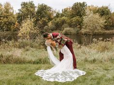 a bride and groom kissing in the grass