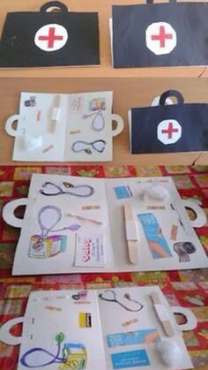 two medical kits sitting on top of a table next to each other with scissors and tape