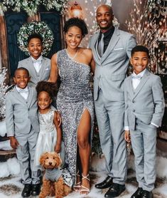 a family posing for a photo in front of a christmas tree