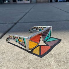 a pair of colorful sunglasses sitting on the ground