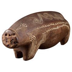 a wooden carved animal with intricate designs on it's body