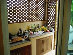 a kitchen counter with various items on it and an open door leading to the outside