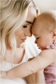 a woman holding a baby in her arms