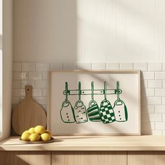 a kitchen scene with lemons on the counter and an art print hanging above it