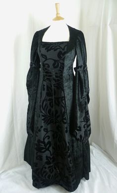 This listing is for a custom made dress,it will be made to the measurements you send me. Please send me your bust,waist and hip measurements,and please measure from the top of your shoulder to the floor with shoes on. It will be made with beautiful jet black crushed velvet and stunning black flocked taffeta....this fabric will also line the inner sleeves.It has a corset style front and back with lacing so you can adjust the dress to fit your body shape. Combined shipping on multiple items. If yo Hooded Gown, Black Gothic Dress, Medieval Wedding Dress, Black Wedding Dress Gothic, Dress Medieval, Black Wedding Gowns, Medieval Gown, Medieval Wedding, Custom Made Dress