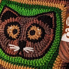 a close up of a crocheted bag with a cat on it