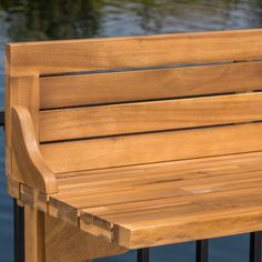 a wooden bench sitting next to a body of water