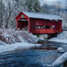 a painting of a covered bridge in winter