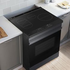 a black stove top oven sitting inside of a kitchen next to a counter with utensils on it