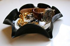 there is a watch and other items in the holder