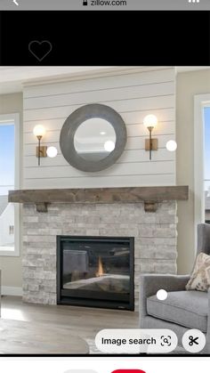 a living room filled with furniture and a fire place in front of a mirror on the wall