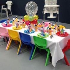 a table set up with balloons, confetti and other items for a children's birthday party