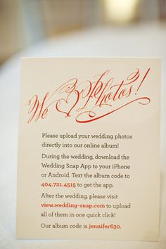 a wedding card that is on top of a white tablecloth with red writing in the middle