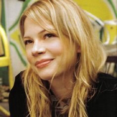 a woman with long blonde hair sitting down