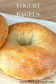 two bagels sitting on top of a cutting board with the words yogurt bagels above them