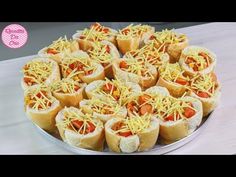 a platter filled with hot dogs covered in cheese