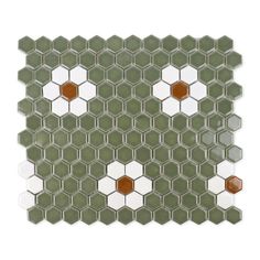 a green and white mosaic tile pattern on the wall, with an orange dot in the center