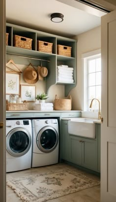 a washer and dryer in a laundry room with baskets on the shelves above