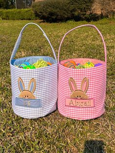 two easter baskets sitting on top of a grass covered field