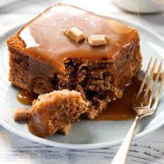 a piece of cake on a plate with caramel drizzle