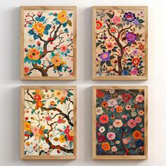 four paintings are hanging on the wall in three different frames, each decorated with colorful flowers