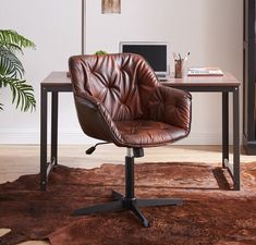 a brown leather office chair sitting in front of a computer desk on top of a rug