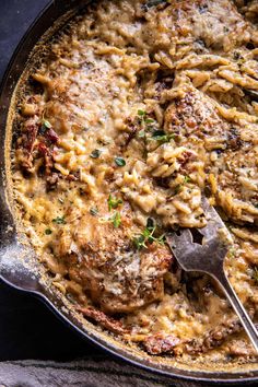 a skillet filled with meatballs covered in gravy and garnished with parsley