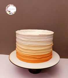 a multi layer cake sitting on top of a white plate next to a brown wall