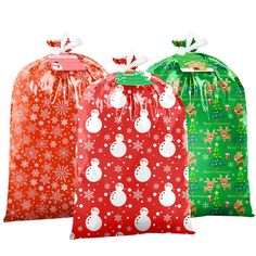 three bags with snowmen on them and christmas decorations in the front, two are red and one is green