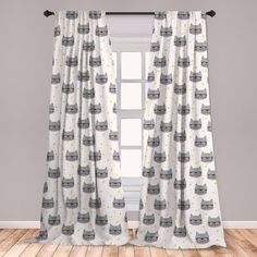 the curtains in this room are decorated with grey and white cat silhouettes on them