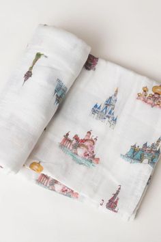 two white sheets with disney castle designs on them