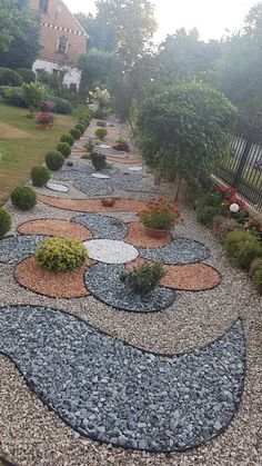 a garden area with gravel and rocks in the shape of mickey mouse's ears