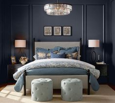 a bedroom with dark blue walls and furniture