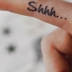 a person's hand with a small tattoo on it that says, shm