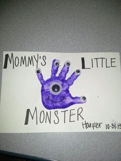 a purple handprint with the words mommy's little monster on it