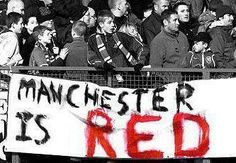 a large group of people in the stands with a banner that reads manchester is red