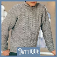 a man wearing a gray sweater and black pants with the words patique written on it