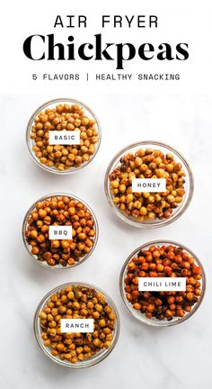 four glass bowls filled with different types of chickpeas on top of a white table