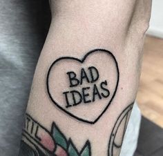 a man's arm with a heart shaped tattoo that says bad ideas on it